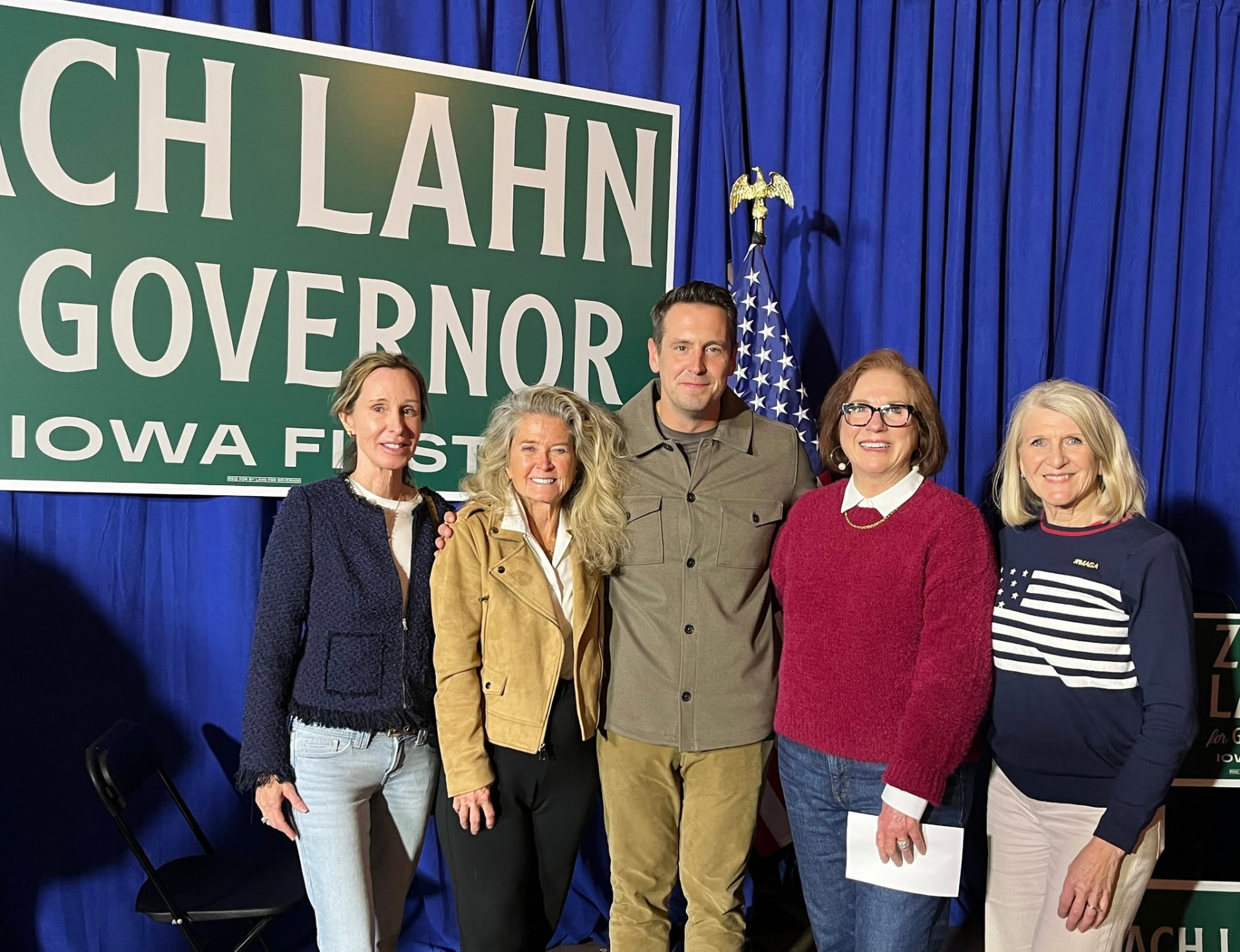Members posing with a candidate at a MAGA Nation Iowa meeting
